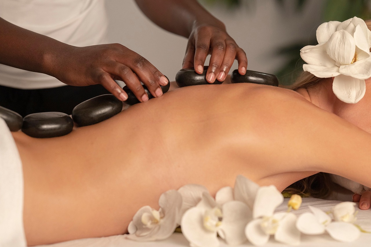 Therapist performing hot stone massage in Hobart CBD near Salamanca Place, calming spa session with smooth basalt stones for deep relaxation.